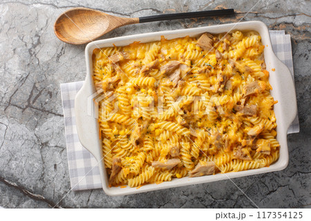 Pasta canned tuna baked with mornay sauce close-up in a baking dish. Horizontal top view 117354125