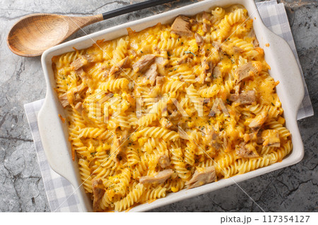 Tuna mornay is a classic Australian cheesy tuna pasta bake closeup on the baking dish. Horizontal top view Tuna mornay is a classic Australian cheesy tuna pasta bake closeup on the baking dish. Horizontal top view 117354127