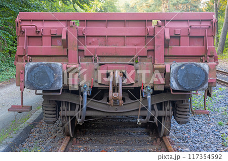 Picture of an cargo railroad car standing on a track photographed from the ground perspective Picture of an cargo railroad car standing on a track photographed from the ground perspective 117354592