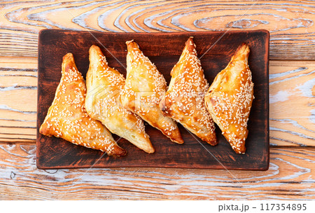 Homemade triangle puff pastry with meat on rustic background . Samosa 117354895