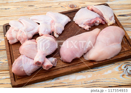Raw mixed chicken meat parts  for cooking on rustic background 117354933