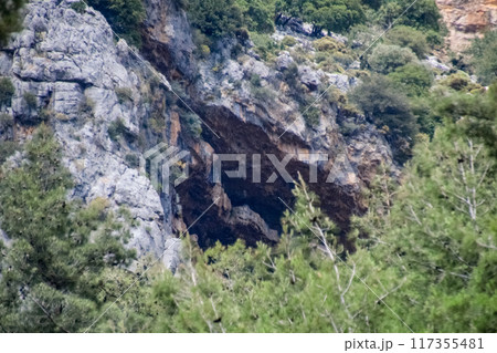 Caves in the limestone mountains. Void in rock mountain. Caves in the limestone mountains. Void in rock mountain. 117355481