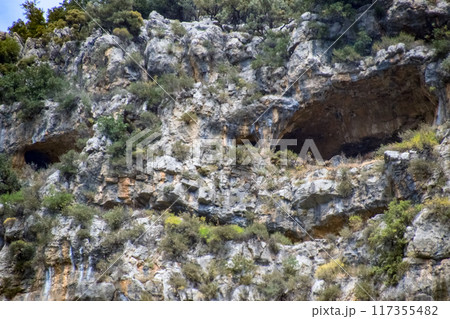 Caves in the limestone mountains. Void in rock mountain. 117355482