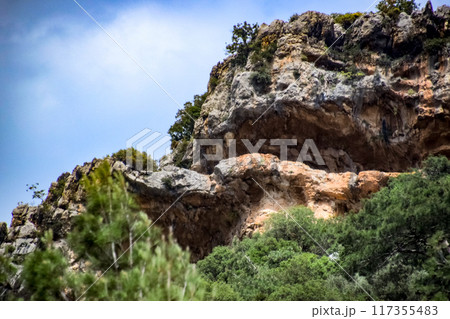 Caves in the limestone mountains. Void in rock mountain. Caves in the limestone mountains. Void in rock mountain. 117355483