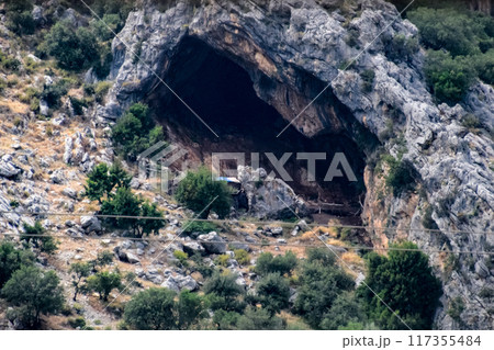 Caves in the limestone mountains. Void in rock mountain. 117355484