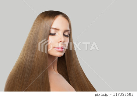 Portrait of female model. Woman with long brown hair, natural makeup and healthy clean skin Portrait of female model. Woman with long brown hair, natural makeup and healthy clean skin 117355593
