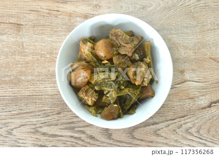 boiled mixed vegetable with braised pork bone in black soybean soup in bowl on table boiled mixed vegetable with braised pork bone in black soybean soup in bowl on table 117356268