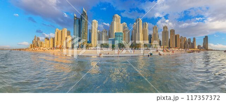 a city view with buildings across the water from a beach a city view with buildings across the water from a beach 117357372