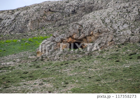 Caves in the limestone mountains. Void in rock mountain. Caves in the limestone mountains. Void in rock mountain. 117358273