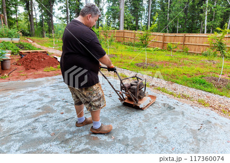 Vibration vibratory tamping machine compacts sand during construction of pool platform Vibration vibratory tamping machine compacts sand during construction of pool platform 117360074