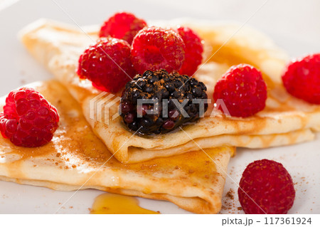 Pancakes with raspberries, blackberries and honey 117361924