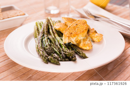 Dietary meal rich in protein. Stir fried chicken breast and green asparagus 117361926