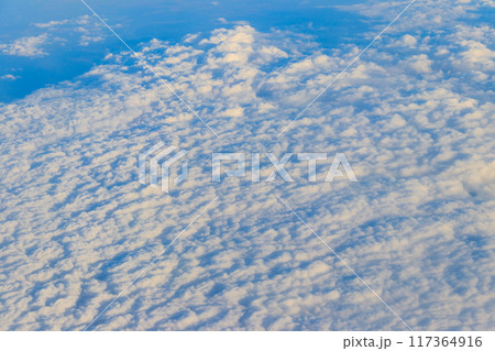 Beautiful white clouds in blue sky. View from airplane 117364916