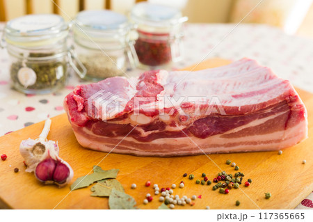 Fresh piece of pork belly on wooden board with spices 117365665