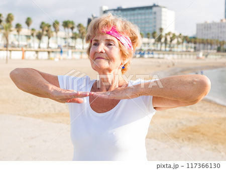 Mature woman training on beach 117366130