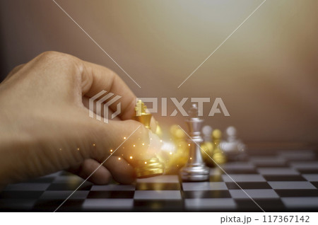 Businessman concept holding gold king chess pieces, silver chess pieces on chessboard for business strategy and leadership delegation concept, leadership success Businessman concept holding gold king chess pieces, silver chess pieces on chessboard for business strategy and leadership delegation concept, leadership success 117367142
