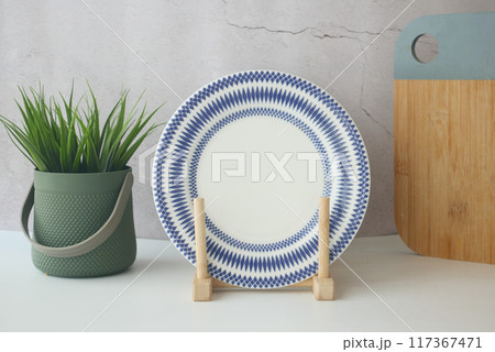round bowl or ceramic plate on kitchen table. 117367471