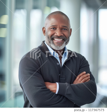 Portrait of an African American male businessman in a suit against the background of an office 117367573