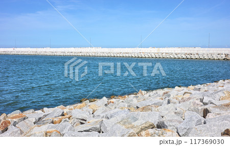 Sea breakwater and rock embankment. Sea breakwater and rock embankment. 117369030
