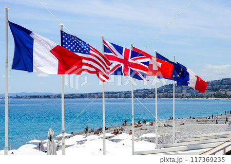Flags of European Union, USA, Great Britain, France and Switzerland on Mediterranean beach Flags of European Union, USA, Great Britain, France and Switzerland on Mediterranean beach 117369235