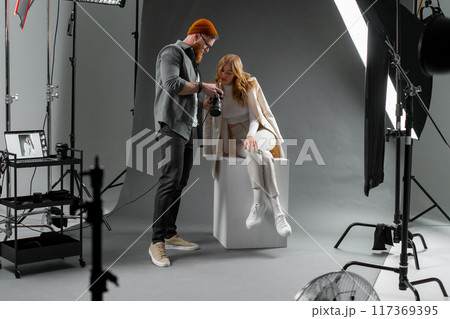 Professional studio photography session with a model and photographer to capture stunning images Professional studio photography session with a model and photographer to capture stunning images 117369395