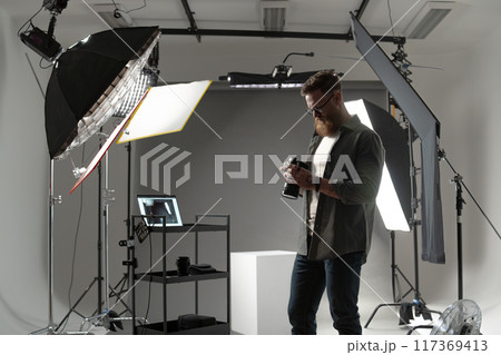 Professional photographer in a studio with specialized equipment for highquality sessions 117369413