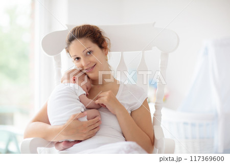 Young mother with newborn baby. 117369600
