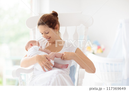 Young mother with newborn baby. 117369649