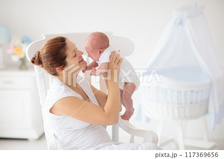 Young mother with newborn baby. Young mother with newborn baby. 117369656