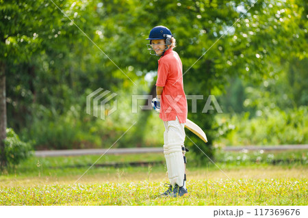 Kids playing cricket in summer park Kids playing cricket in summer park 117369676
