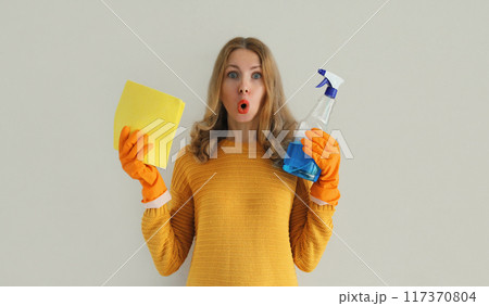House cleaning, housewife or cleaner, woman holding dry microfiber rag and detergent spray bottle House cleaning, housewife or cleaner, woman holding dry microfiber rag and detergent spray bottle 117370804