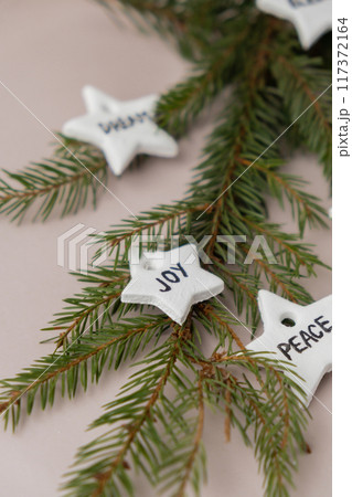 Christmas star with word JOY Group of air dry clay handmade Christmas decor on beige background. Children air dry clay activity handicraft idea. Preparing for Christmas holiday decorating. Modern Christmas star with word JOY Group of air dry clay handmade Christmas decor on beige background. Children air dry clay activity handicraft idea. Preparing for Christmas holiday decorating. Modern 117372164