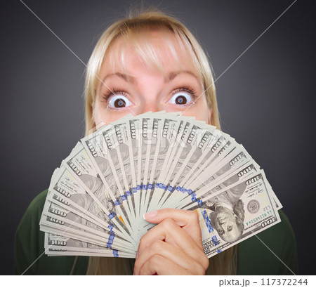 Girl Holding Thousands of Dollars in One Hundred Dollar Bills Fanned Out In Her Hand. Girl Holding Thousands of Dollars in One Hundred Dollar Bills Fanned Out In Her Hand. 117372244