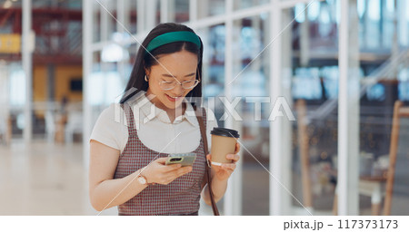 Phone, coffee and businesswoman in the airport networking on social media, mobile app or the internet. Technology, smile and young Asian female person scroll on website with cellphone in hotel lobby. Phone, coffee and businesswoman in the airport networking on social media, mobile app or the internet. Technology, smile and young Asian female person scroll on website with cellphone in hotel lobby. 117373173