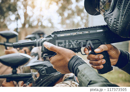 Paintball, gun and target with team, action and sports outdoor, people on battlefield and soldier focus during war game. Extreme sport, aim and military mission, exercise and fitness with motion blur 117373505