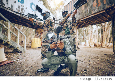 Paintball teamwork, shooting together and war game with vision, mask or tactical strategy for safety in competition. Military training, team building or group for weapon, formation or friends outdoor 117373539