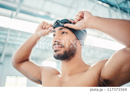 Swimming athlete, man and start race, fitness and exercise at pool, motivation and active lifestyle. Water sports, determination and face with workout, training and health with wellness in sport 117373569