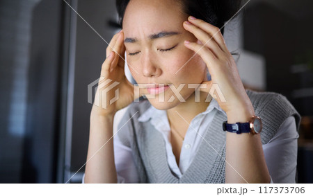 Stress, headache and woman with burnout, anxiety and problems with mental health at night. Tired, pain and asian girl suffering from insomnia, stressed and pressure, unhappy and frustrated Stress, headache and woman with burnout, anxiety and problems with mental health at night. Tired, pain and asian girl suffering from insomnia, stressed and pressure, unhappy and frustrated 117373706