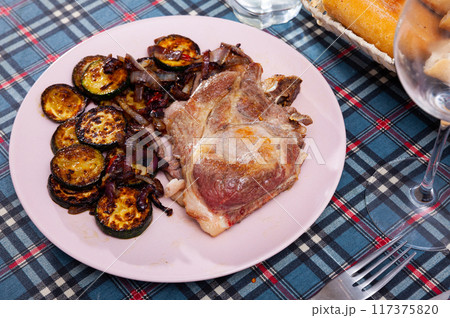 Roasted pork chop with zucchini Roasted pork chop with zucchini 117375820