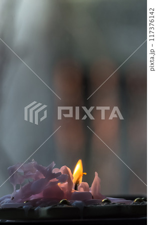 Burning candle in the dark. Shallow depth of field. 117376142