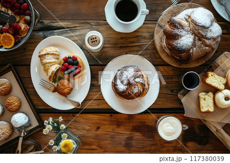 Gourmet breakfast scene featuring a beautifully crafted pastry, a cup of coffee, fresh berries, and a cinnamon drink.. 117380039