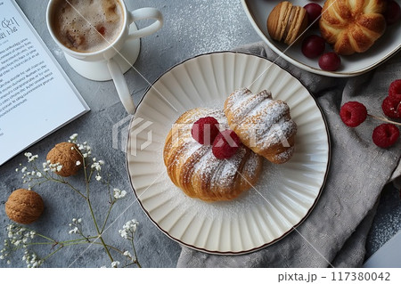 Gourmet breakfast scene featuring a beautifully crafted pastry, a cup of coffee, fresh berries, and a cinnamon drink.. Gourmet breakfast scene featuring a beautifully crafted pastry, a cup of coffee, fresh berries, and a cinnamon drink.. 117380042