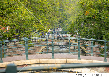 Amsterdam Canal Bridges Surrounded by Green Trees 117381152