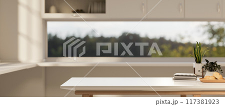 A copy space for displaying products on a white kitchen table in a white and clean kitchen. A copy space for displaying products on a white kitchen table in a white and clean kitchen. 117381923