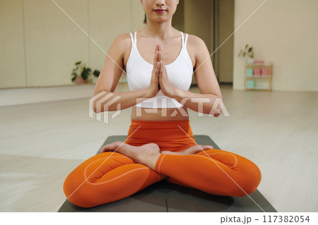 Practicing Yoga with Focus and Calmness in Studio Setting Practicing Yoga with Focus and Calmness in Studio Setting 117382054