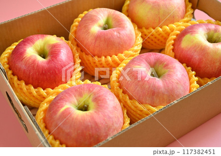 beautiful pink apple in the box on pink background 117382451