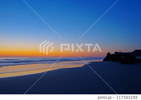 朝焼けの空を背景に静かな波が打ち寄せる薄磯海岸と塩屋崎灯台の風景　Ver3 117383288