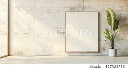 Modern indoor setting with blank frame and potted palm plant against textured wall 117383616