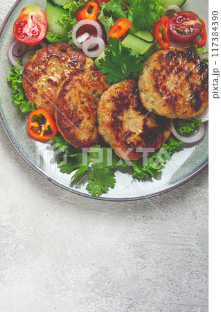 fried chicken cutlets, minced chicken, with vegetables, on gray , with vegetable salad, top view, homemade, no people, 117384390