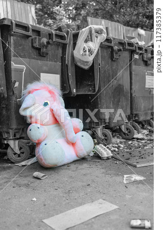 abandoned plush toy. toy pink elephant. discarded dumpster toy. landfill. 117385379